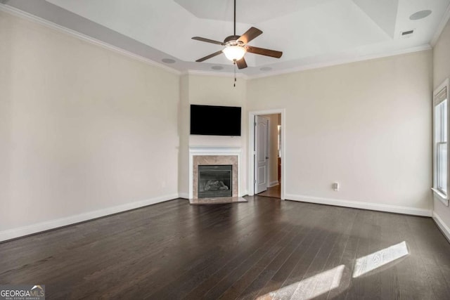 unfurnished living room with ceiling fan, ornamental molding, and dark hardwood / wood-style floors