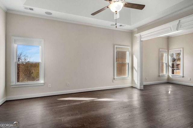 unfurnished room with ceiling fan, dark wood-type flooring, crown molding, and a tray ceiling