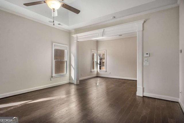 unfurnished room featuring ceiling fan, a tray ceiling, crown molding, and dark hardwood / wood-style floors