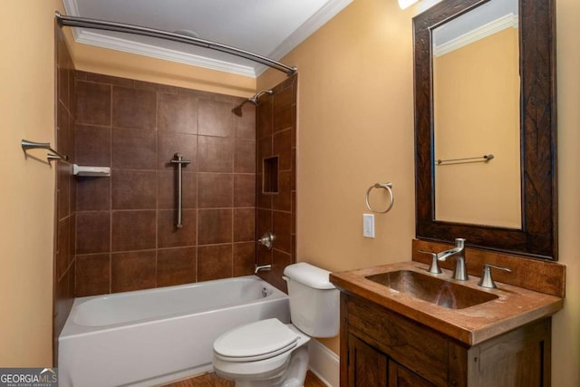 full bathroom with ornamental molding, tiled shower / bath, vanity, and toilet