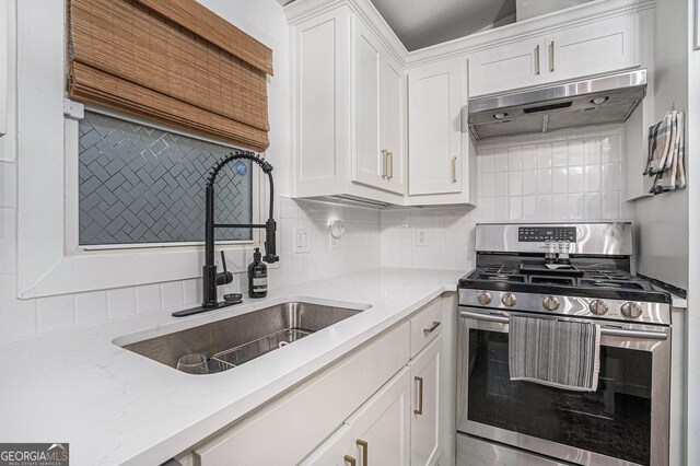 kitchen featuring stainless steel dishwasher, a chandelier, backsplash, white cabinets, and sink