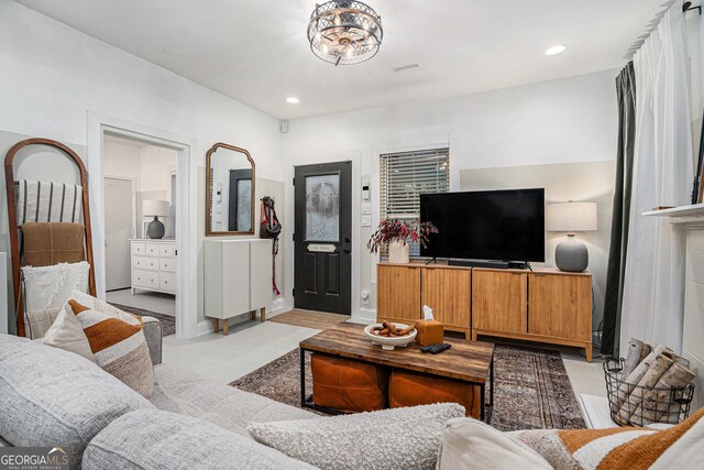 kitchen with appliances with stainless steel finishes, white cabinets, sink, and a kitchen island