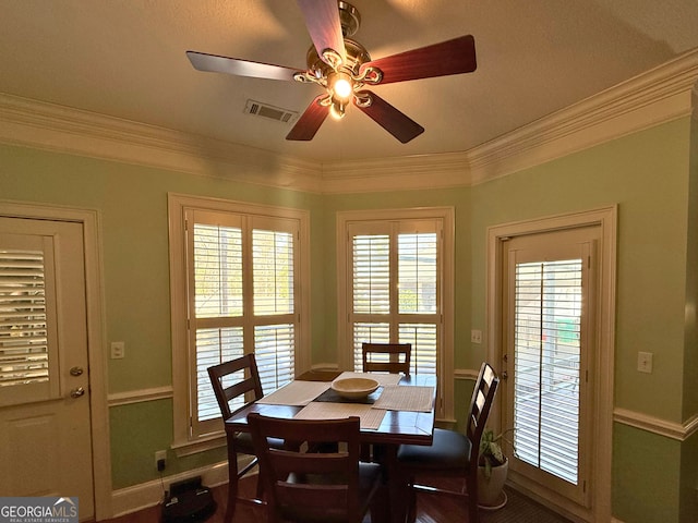 dining room with ceiling fan and crown molding