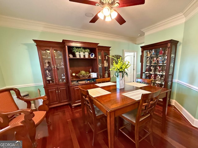 dining area featuring ceiling fan, crown molding, and dark hardwood / wood-style floors