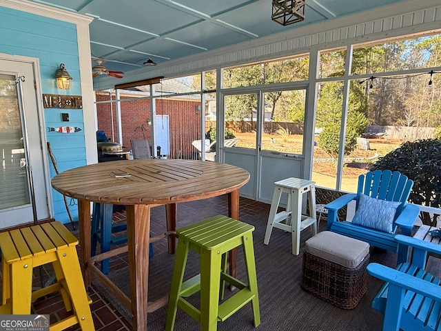 sunroom / solarium featuring ceiling fan