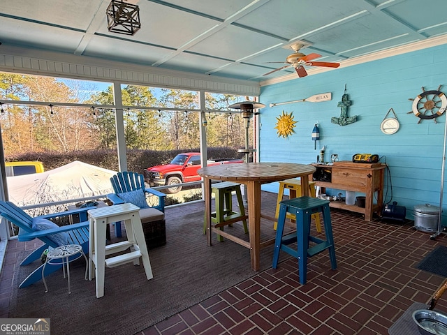 sunroom featuring ceiling fan