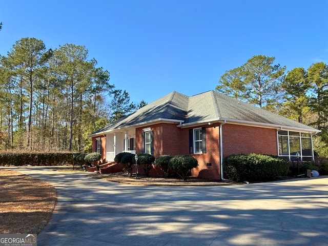 view of side of property with a sunroom