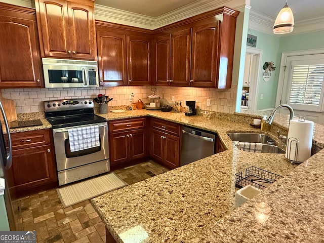 kitchen featuring appliances with stainless steel finishes, light stone countertops, sink, decorative light fixtures, and tasteful backsplash