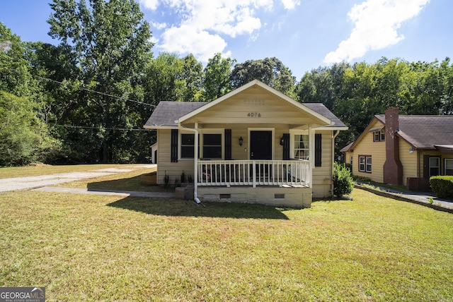 bungalow-style house featuring a front yard and covered porch