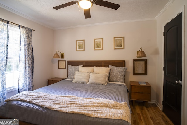 bedroom with a textured ceiling, ceiling fan, crown molding, and dark hardwood / wood-style floors