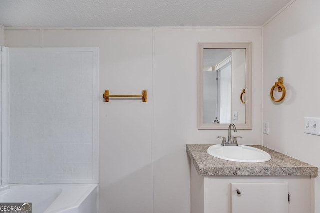 bathroom with a textured ceiling and vanity