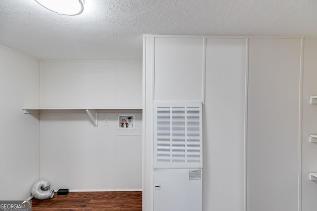 laundry area featuring laundry area, washer hookup, a textured ceiling, and wood finished floors