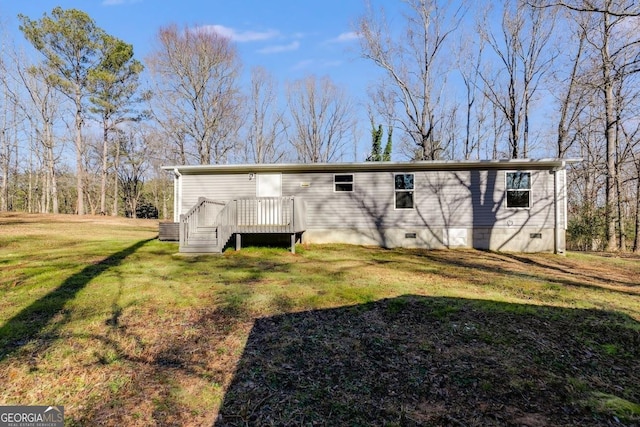 back of house featuring a deck, a yard, and crawl space