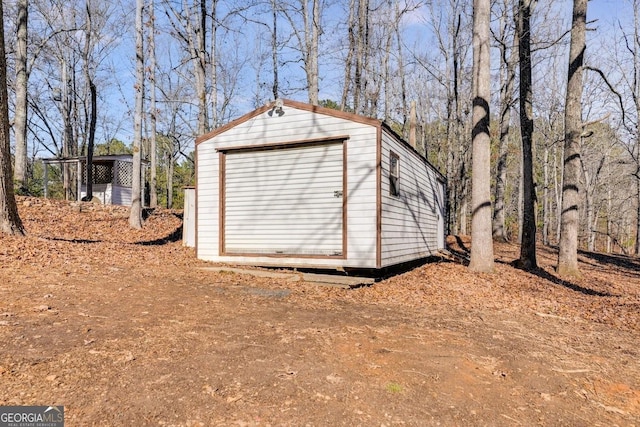 view of shed with dirt driveway