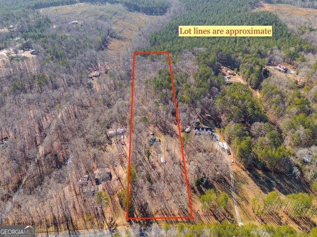 birds eye view of property with a view of trees