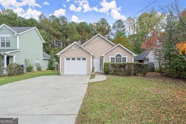 view of front of property with a garage and a front lawn