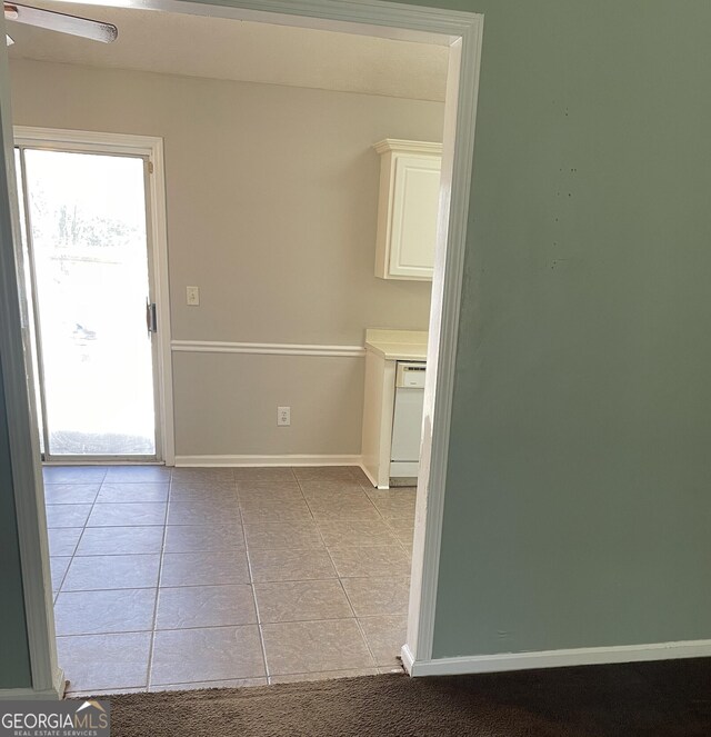 tiled spare room featuring ceiling fan and lofted ceiling