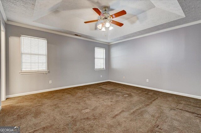 unfurnished bedroom with a spacious closet, ceiling fan, a closet, carpet floors, and crown molding