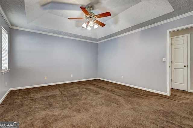 carpeted spare room with a raised ceiling, a textured ceiling, ceiling fan, and ornamental molding