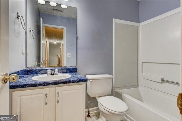 unfurnished bedroom with dark carpet, a textured ceiling, ceiling fan, and a closet