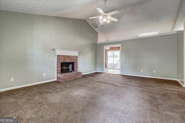 unfurnished living room with lofted ceiling, a fireplace, carpet floors, and ceiling fan