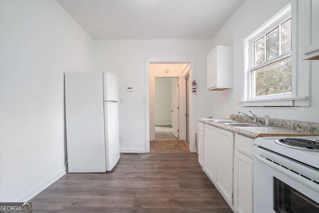 kitchen with sink, white appliances, white cabinets, and dark hardwood / wood-style floors