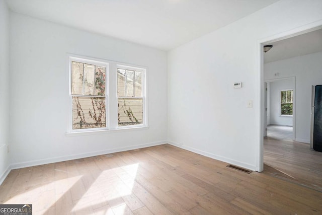 unfurnished room featuring light hardwood / wood-style flooring