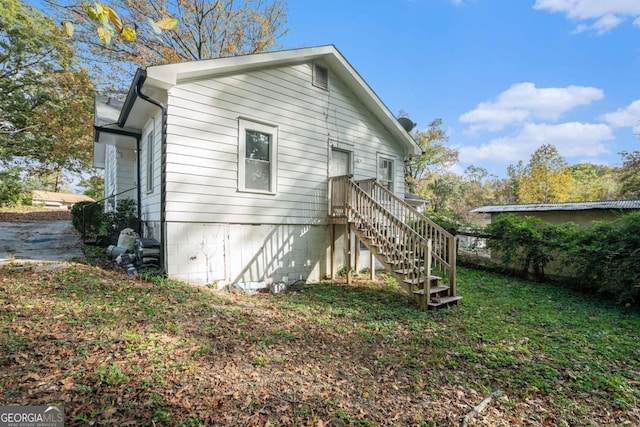 rear view of property with a lawn