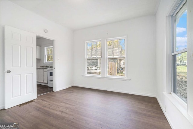 unfurnished room with dark hardwood / wood-style floors