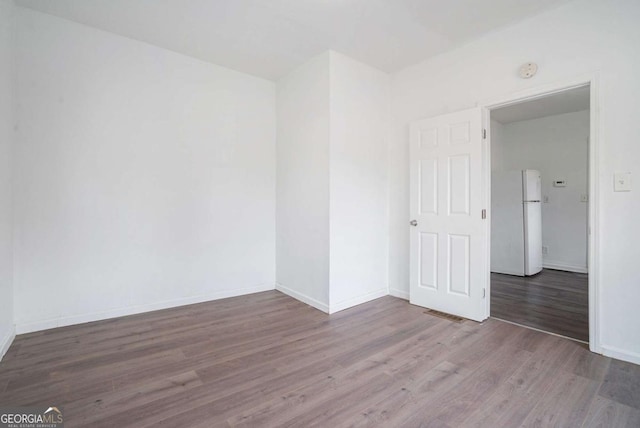 empty room featuring wood-type flooring