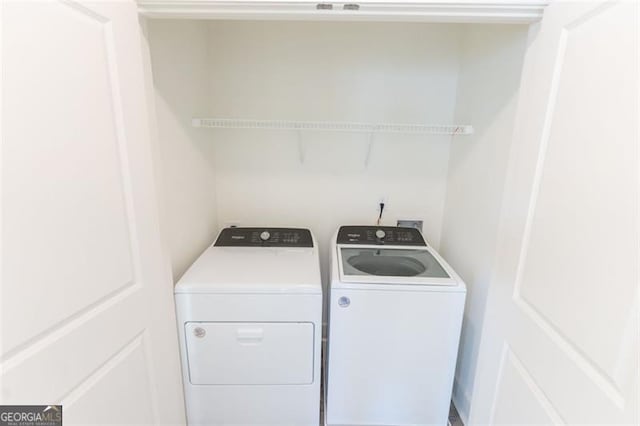 clothes washing area featuring washer and clothes dryer