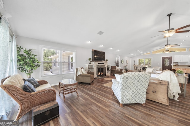 living room featuring ceiling fan, lofted ceiling, and dark hardwood / wood-style floors