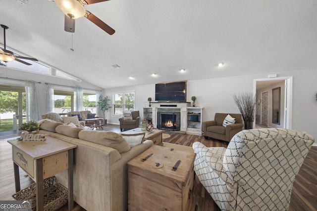 living room with ceiling fan, hardwood / wood-style floors, and lofted ceiling