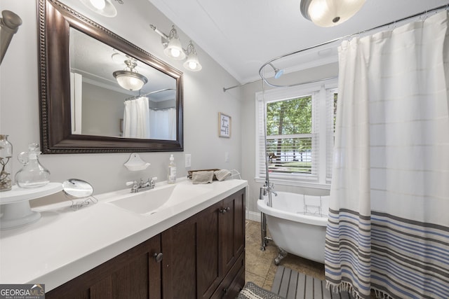 bathroom with ornamental molding, vanity, lofted ceiling, and tile patterned floors