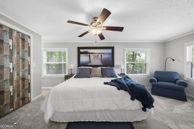 bedroom featuring ornamental molding, light colored carpet, ceiling fan, and a textured ceiling