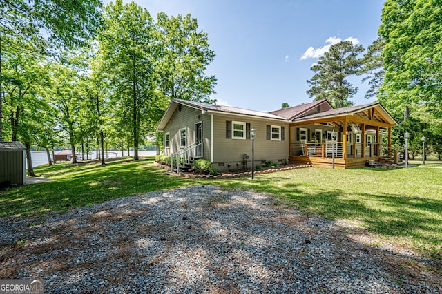 exterior space featuring a lawn and covered porch