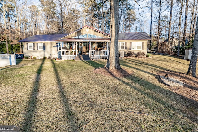 ranch-style home with a front yard, a porch, and central AC