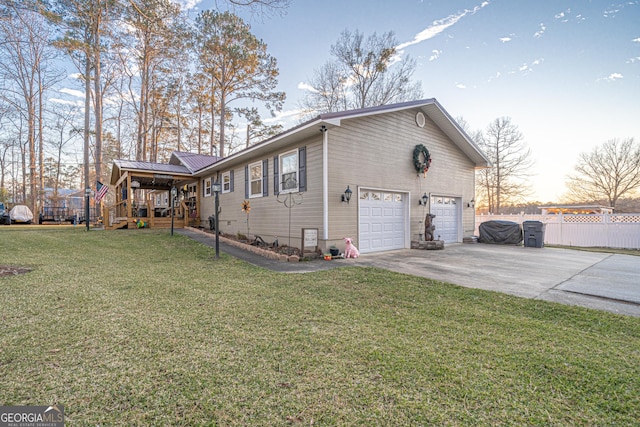 property exterior at dusk with a garage and a yard