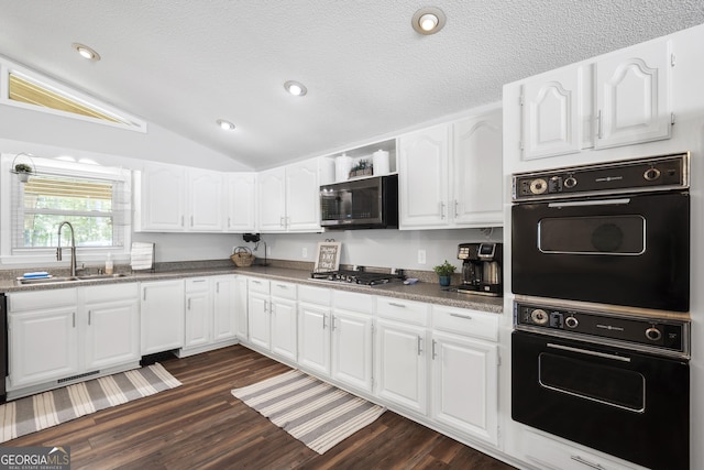 kitchen with sink, white cabinetry, lofted ceiling, stainless steel gas stovetop, and dark hardwood / wood-style flooring