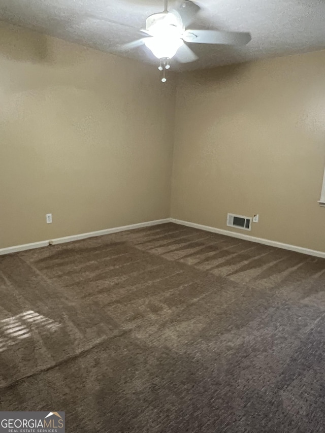 carpeted empty room with a textured ceiling and ceiling fan