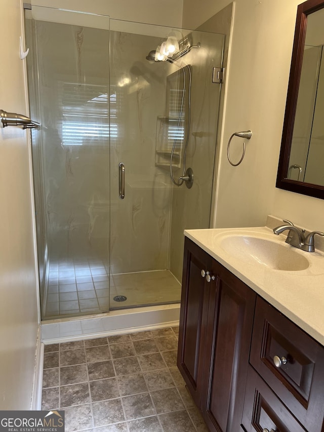 bathroom with a shower with door and vanity