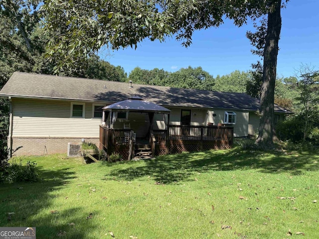 back of house with a gazebo, a yard, and a deck