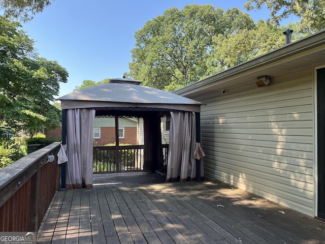 wooden terrace featuring a gazebo