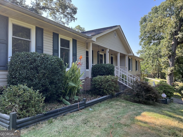 view of front of property with covered porch and a front yard