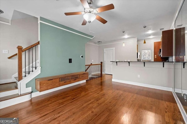 living room featuring ceiling fan and hardwood / wood-style flooring