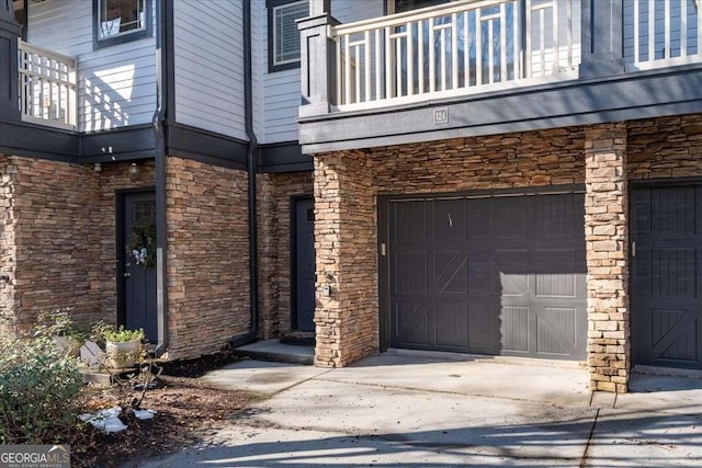 doorway to property featuring a balcony and a garage