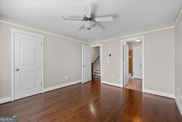 unfurnished room featuring ceiling fan, crown molding, and dark hardwood / wood-style flooring