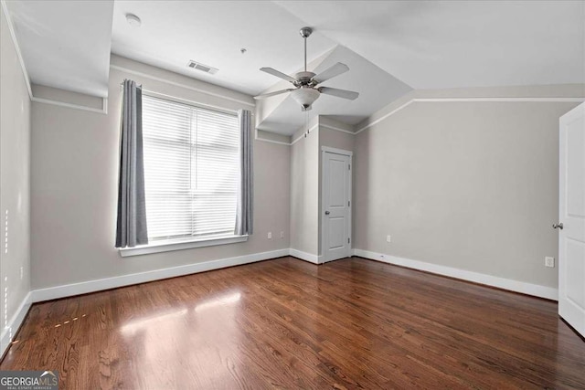 additional living space with lofted ceiling, ceiling fan, a wealth of natural light, and dark hardwood / wood-style floors