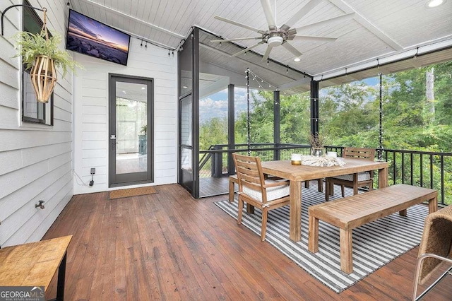 sunroom featuring ceiling fan and vaulted ceiling