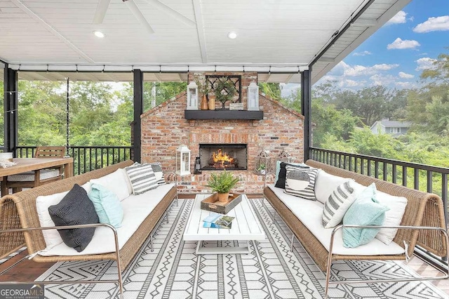 sunroom featuring an outdoor brick fireplace